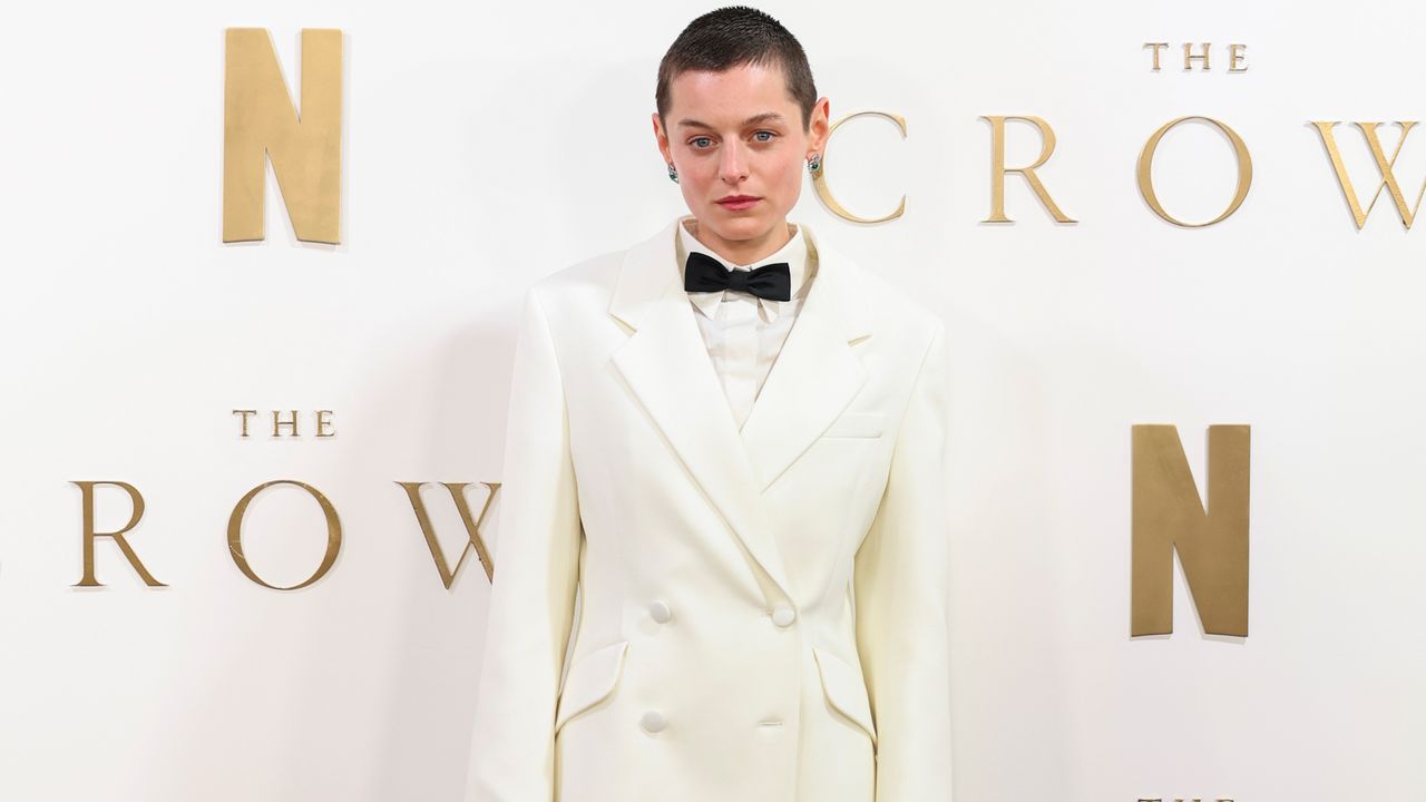 Emma Corrin in a Princess Diana inspired white blazer, bow tie, and sheer skirt by Miu Miu