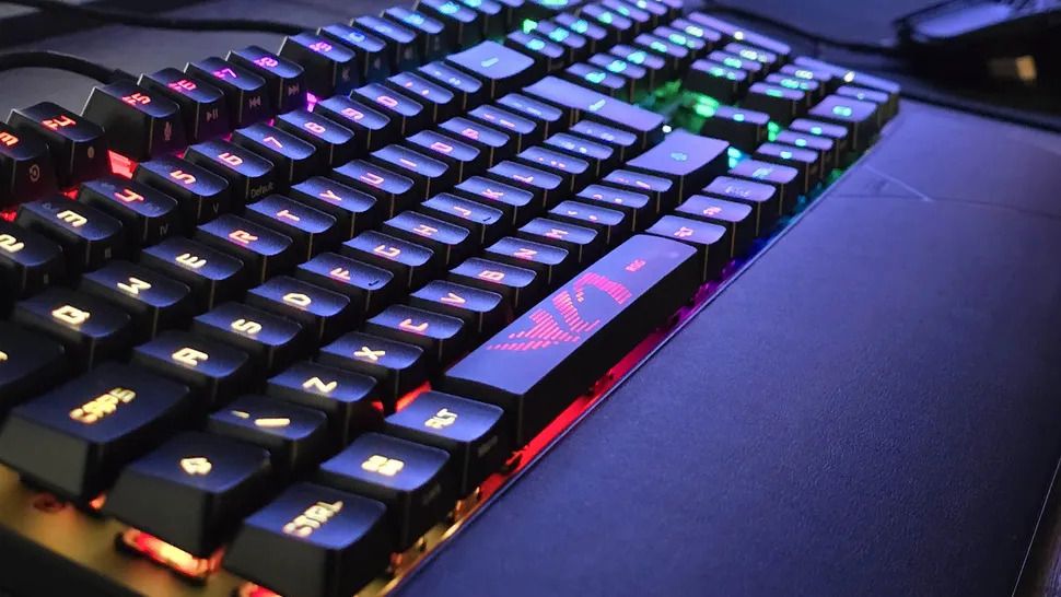 a beautifully lit picture of an Asus ROG Strix Scope II RX gaming keyboard, at night