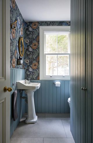 A bathroom with a large print wallpaper