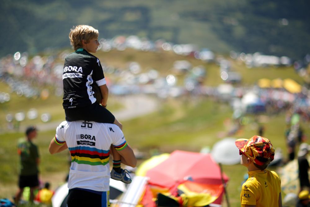 A father and son take in the sights on one of the climbs during stage 12