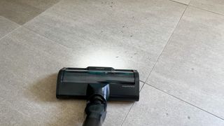 Samsung Bespoke Jet AI's Dual Active Brush on a dirty tile floor