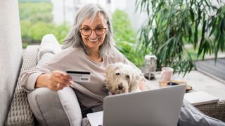 Woman and dog shopping online together for the best Amazon Prime Day pet deals