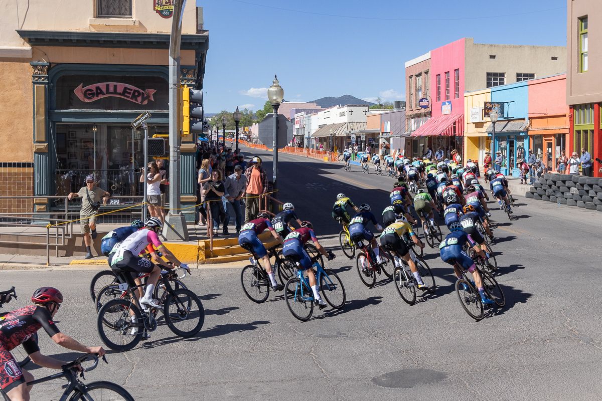 Men's peloton navigating the fourth and final corner onto N Bullard St.