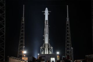 A SpaceX Falcon 9 rocket and Dragon cargo ship stand atop their Cape Canaveral Air Force Station launchpad in Florida on the eve of a June 29, 2018 launch.