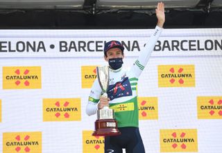 BARCELONA SPAIN MARCH 28 Podium Adam Yates of United Kingdom and Team INEOS Grenadiers Green Leader Jersey Celebration during the 100th Volta Ciclista a Catalunya 2021 Stage 7 a 133km stage from Barcelona to Barcelona Mask Covid safety measures Trophy VoltaCatalunya100 on March 28 2021 in Barcelona Spain Photo by David RamosGetty Images