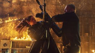 Eve Macarro fights a foe as they both wield flamethrowers in From the World of John Wick: Ballerina