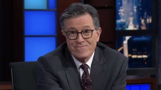 Stephen Colbert looking into camera and smirking on The Late Show with Stephen Colbert