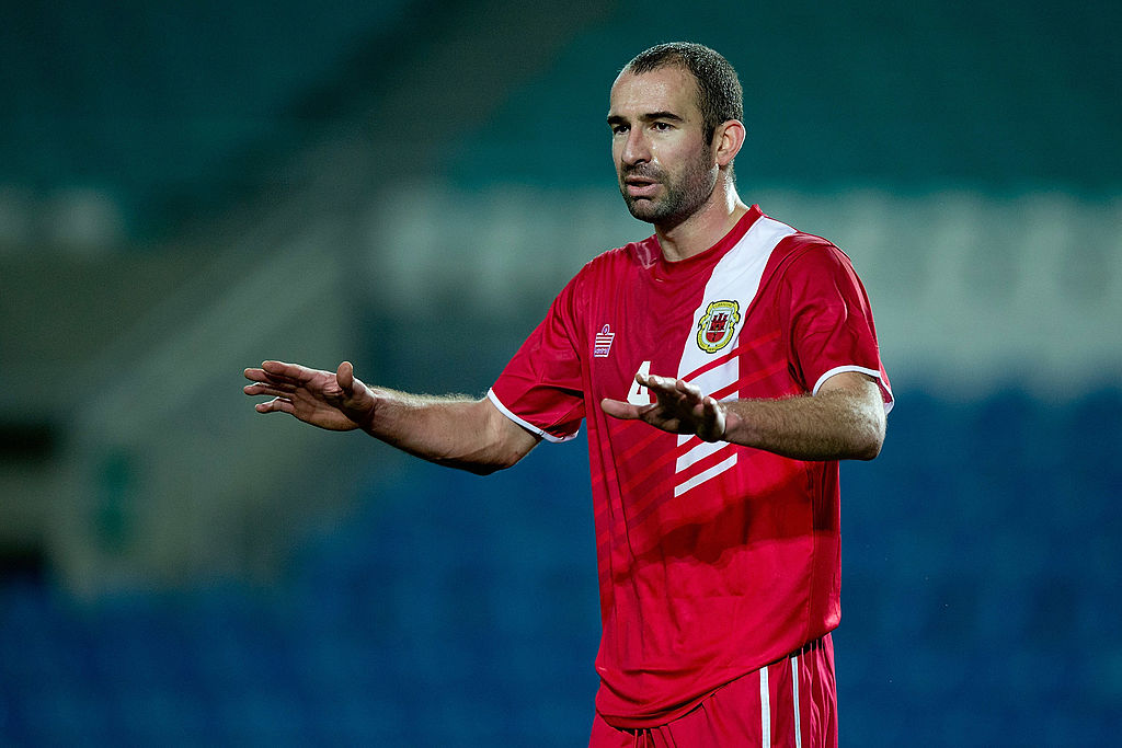 Danny Higginbotham of Gibraltar gives instructions to his teammates during the international friendly match between Gibraltar and Slovakia at Estadio do Alagarve on November 19, 2013 in Faro, Portugal.