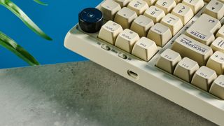 A beige, brown and off-white Epomaker RT100 wireless mechanical keyboard