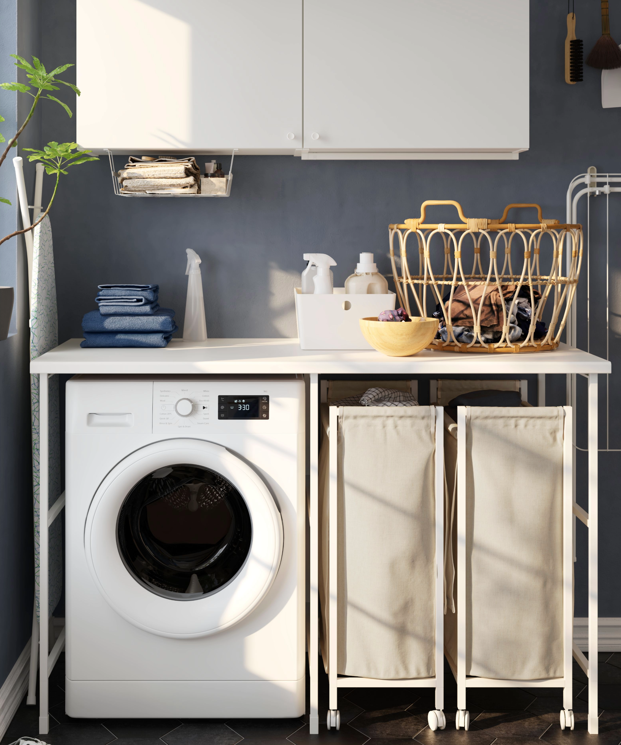 Ikea utility room idea with a worktop above a washer and laundry baskets