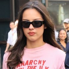 Olivia Rodrigo wore a graphic tee and leather mini skirt with an on-sale Coach bag