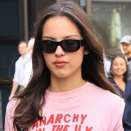 Olivia Rodrigo wore a graphic tee and leather mini skirt with an on-sale Coach bag