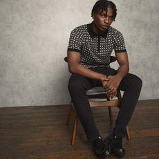 Male model wearing Burton clothing sat on a chair