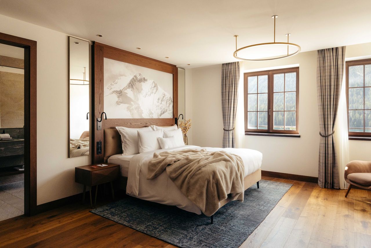 A hotel bedroom furnished in neutral tones