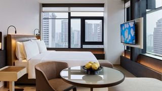 A clean and luxury hotel room with a view of Singapore at Como Hotels