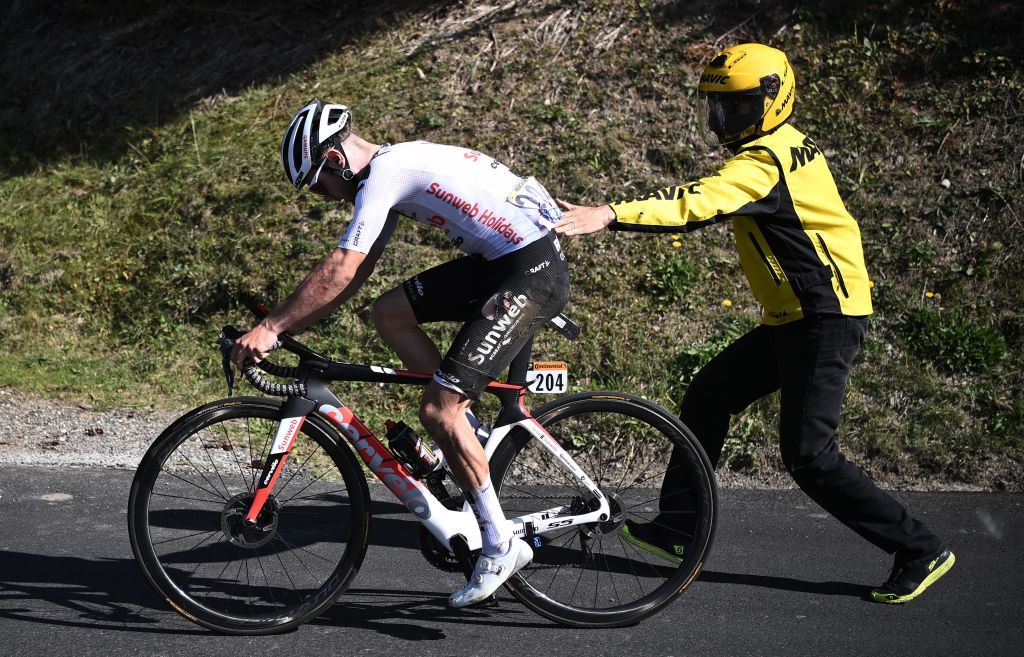 Team Sunweb rider Switzerlands Marc Hirschi is pushed forward after crashing during the 18th stage of the 107th edition of the Tour de France cycling race 168 km between Meribel and La Roche sur Foron on September 17 2020 Photo by Marco BERTORELLO AFP Photo by MARCO BERTORELLOAFP via Getty Images