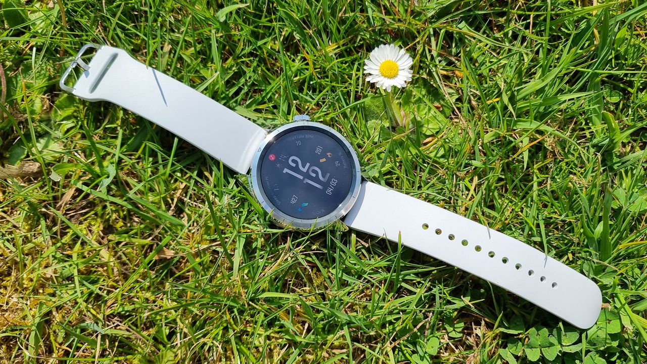 The Xiaomi Watch S4 laying flat on the grass