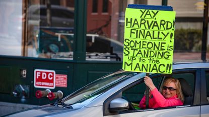 Protester cheers Harvard's pushback against Trump administration demands