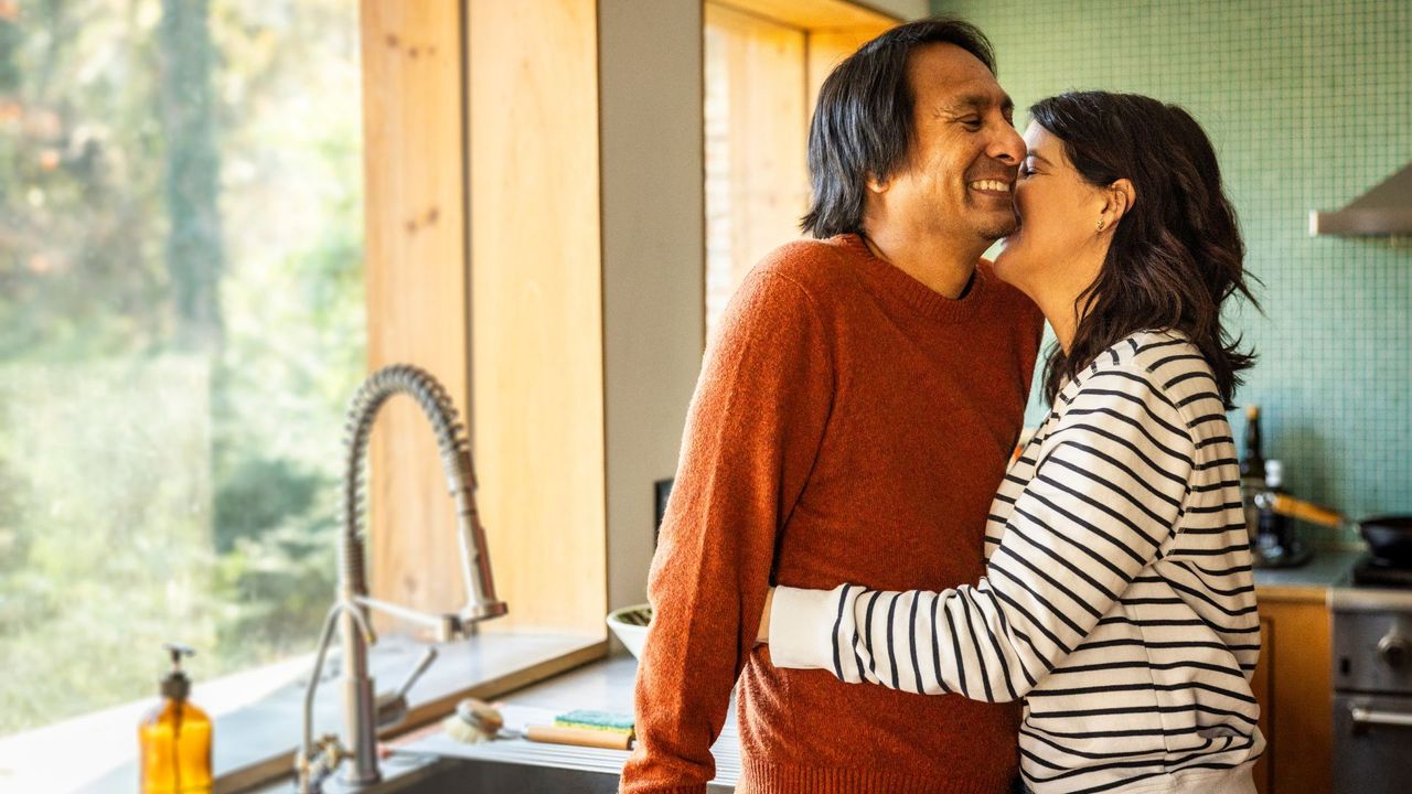 Couple kissing in kitchen