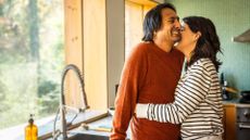 Couple kissing in kitchen