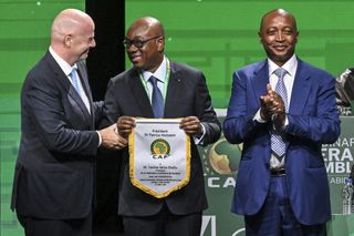 Ivory Coast's Football Federation president Yacine Idriss Diallo (C) pose with African Confederation of Football (CAF) president Patrice Motsepe (R) and FIFA president Gianni Infantino (L) during the CAF 45th Ordinary General Assembly in Abidjan in Ivory Coast on July 13, 2023.