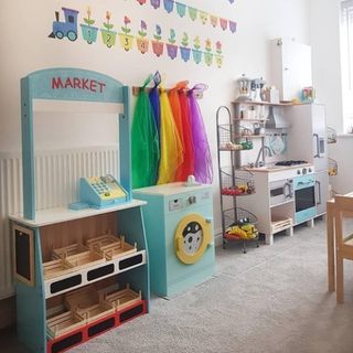 playroom with light pink wall and open shelve