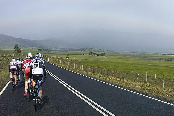 Stormy weather brewing: the lead group head for the hills in the background and the climb up Poatina.