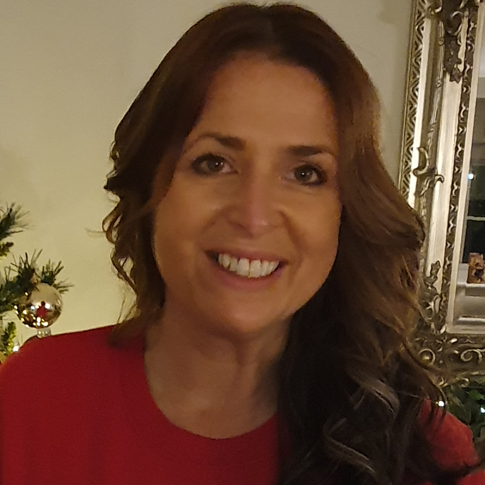 female with long brown hair wearing red top