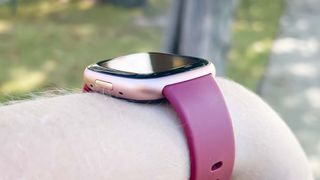 Fitbit Versa 4 on a person's wrist showing the customizable strap