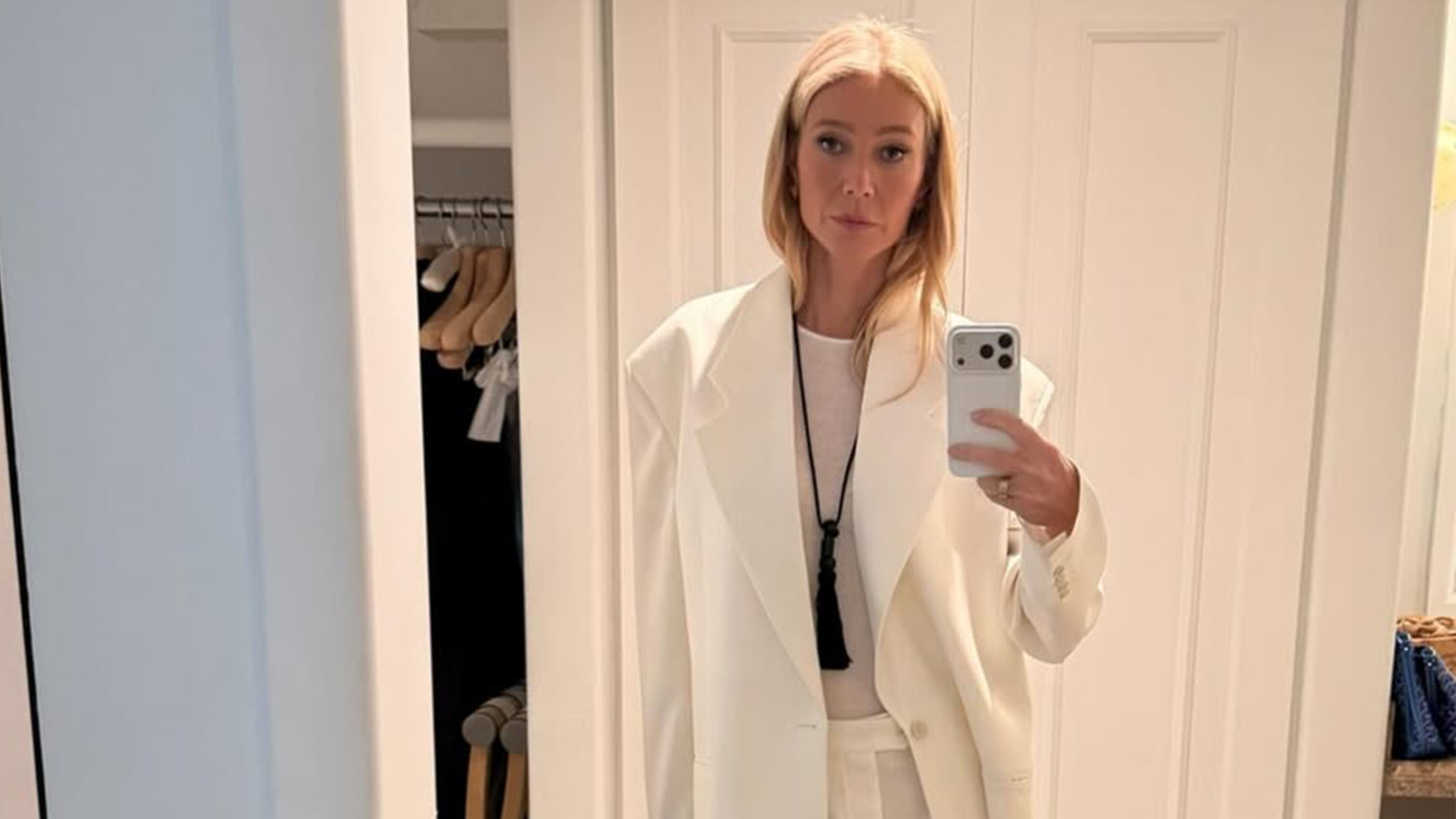 Gwenyth Paltrow wearing a white suit and onyx necklace