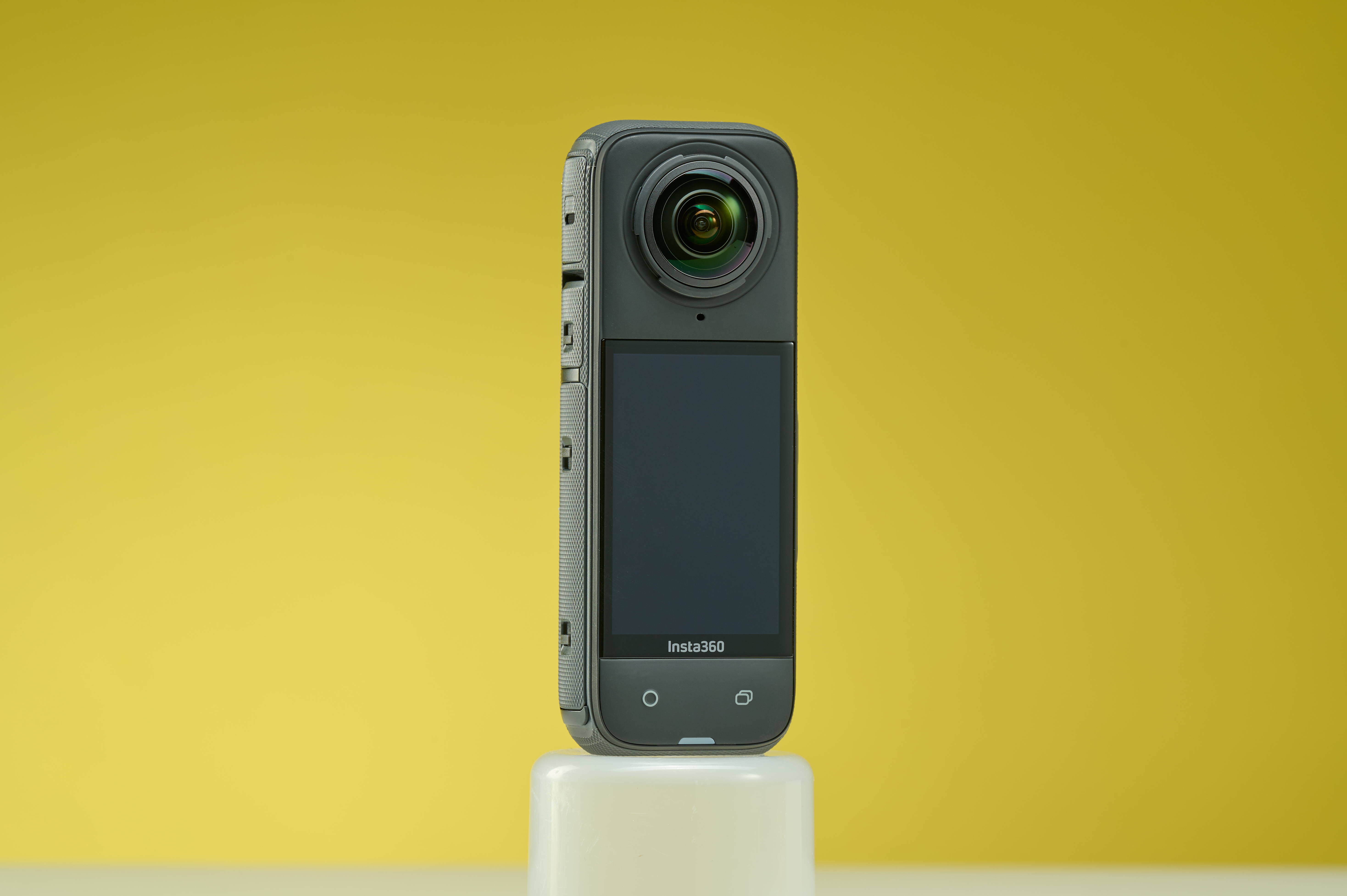 Insta360 X4 in black set to a contrasting yellow background