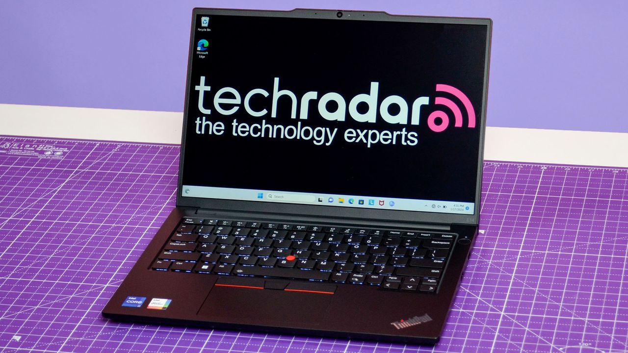 An Lenovo ThinkPad E14 Gen 5 on a purple deskmat