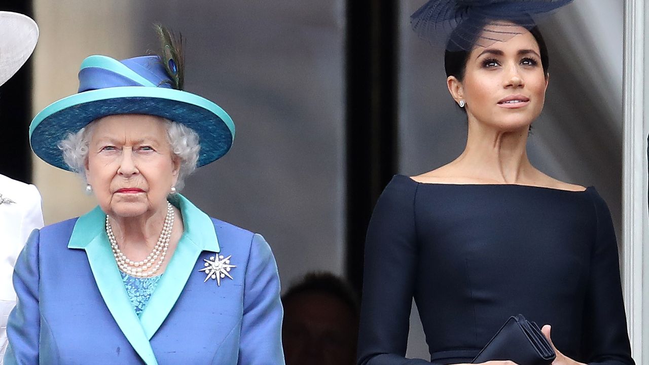 Queen Elizabeth II and Meghan, Duchess of Sussex on the balcony of Buckingham Palace as the Royal family attend events to mark the Centenary of the RAF on July 10, 2018