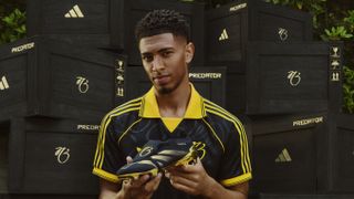 Jude Bellingham holding a pair of Adidas Predators