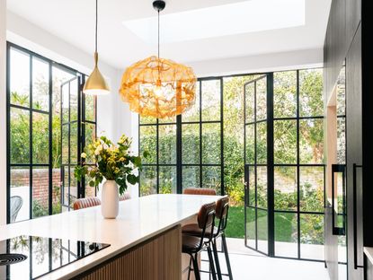 steel framed doors in a kitchen leading to a back garden