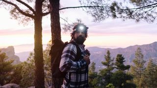 man wearing a headlamp during a hike