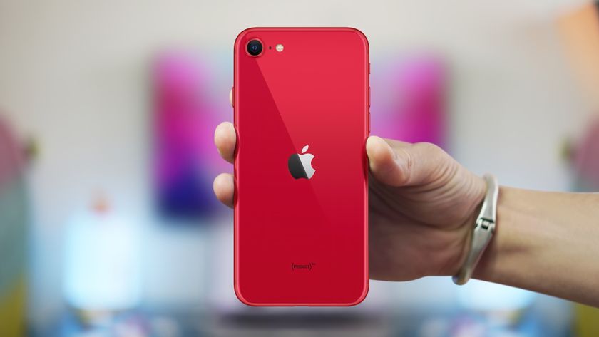 Red iPhone SE in someone&#039;s hand