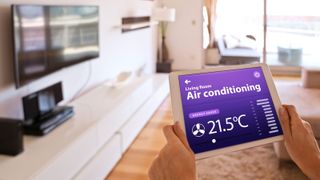 oman controlling air conditioner with a digital tablet at home