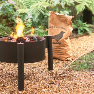 compact fire pit at outdoor brown bag of charcoal
