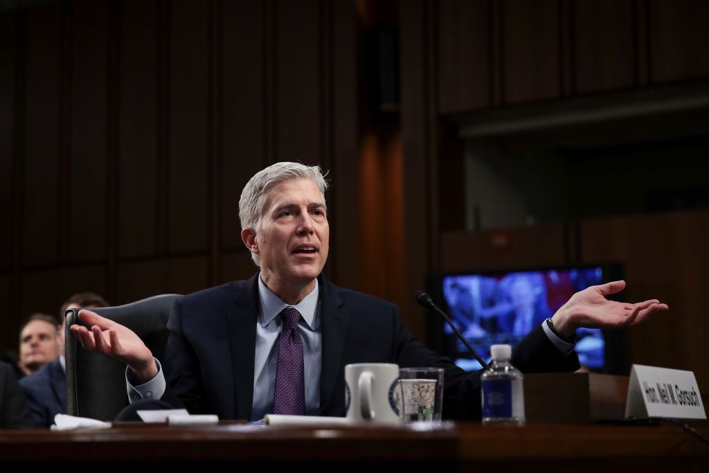 Neil Gorsuch shrugs as he sits in the Senate.