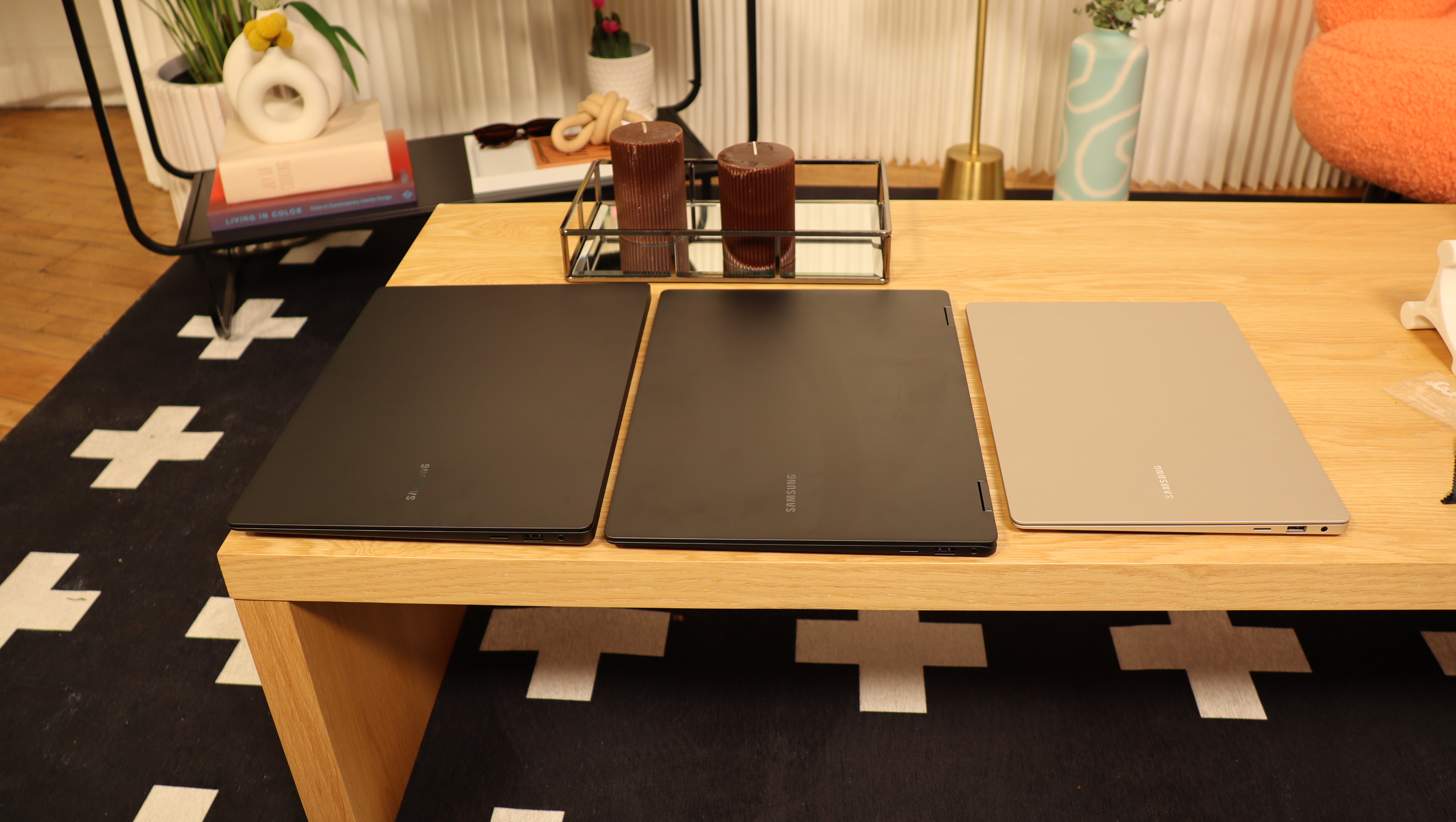 Three Samsung Galaxy Book3 sat next to each other on a wooden table