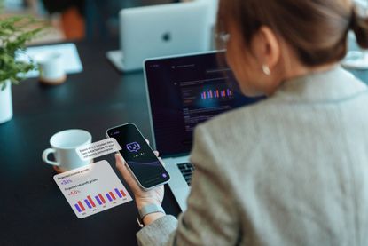 Woman using AI on smartphone for financial advice