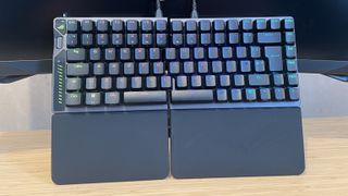 Asus ROG Falcata gaming keyboard on a wooden desk