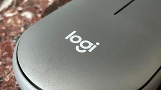 The Logitech logo on the back of the Logitech Pebble Mouse 2 M350S mouse.