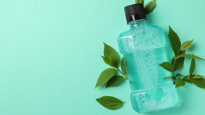 bottle of mouthwash on blue background