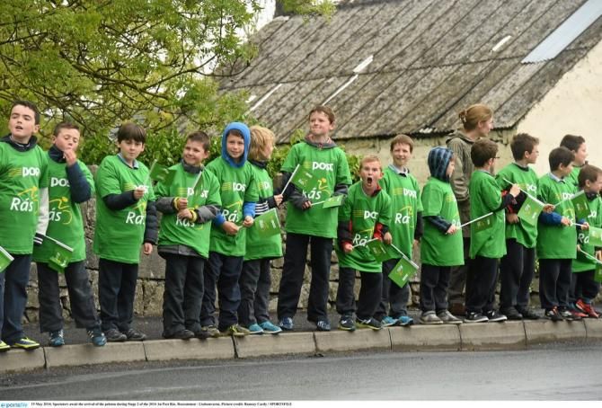 Spectators await the arrival of the peloton during Stage 2