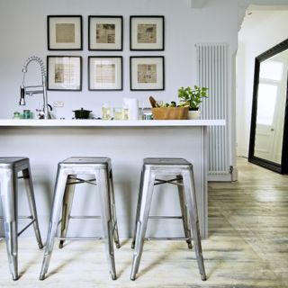 Grey kitchen island with metal bar stools