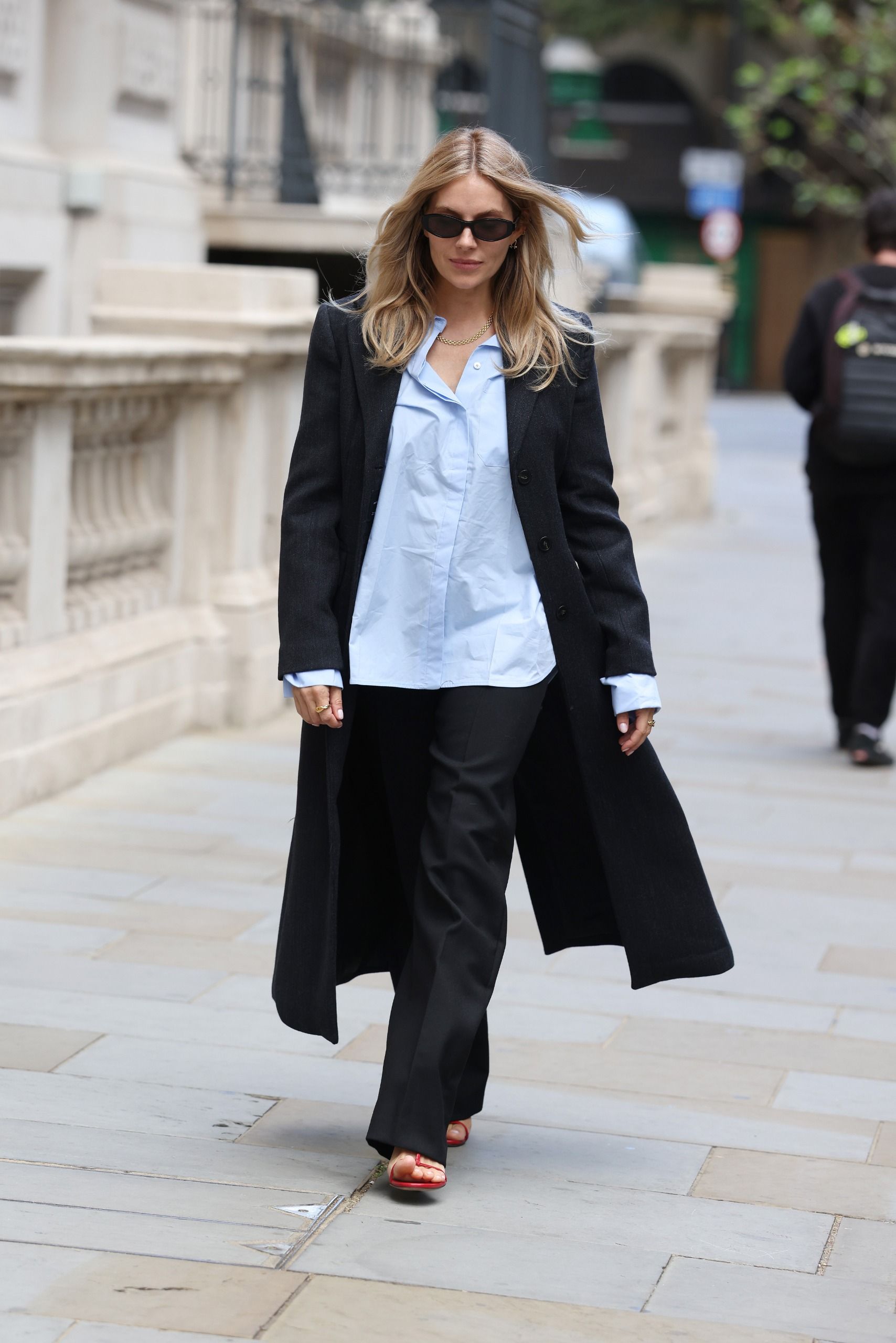 Sienna Miller wears a Mango coat, shirt and trousers in London