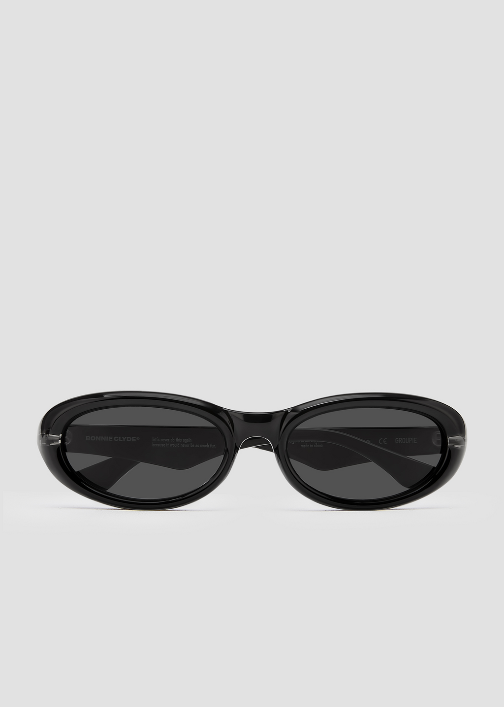 Groupie sunglasses in front of a plain backdrop