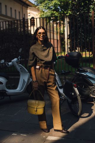 Woman at Fashion Week walking in the street wearing loafers,